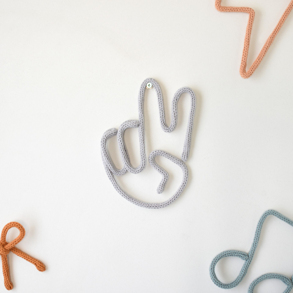 Knitted peace hand sign