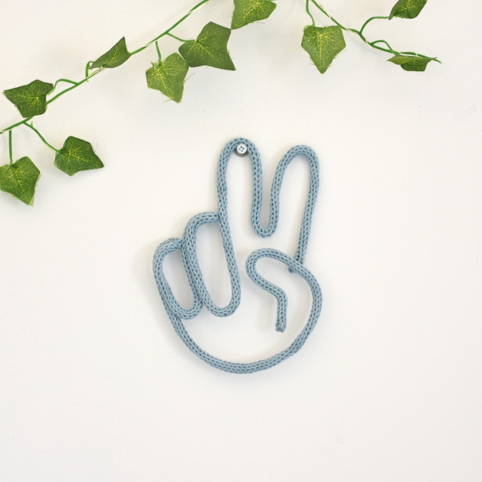 Knitted peace hand sign
